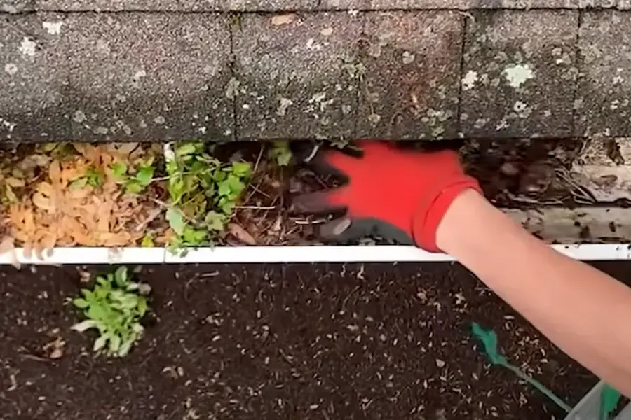 Rinsing a gutter after removing loose debris
