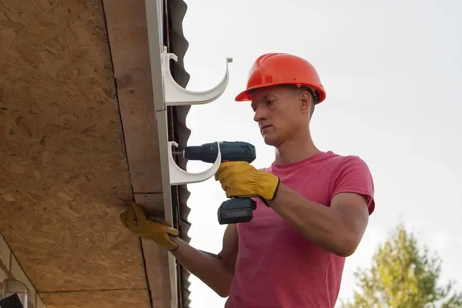 Repairing a residential gutter at the roof edge