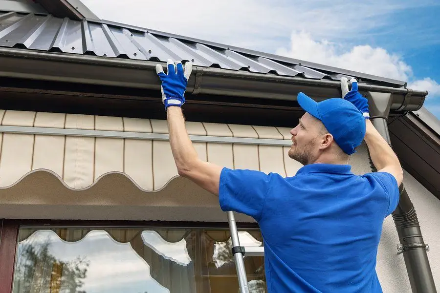 Gutter work performed from a secured ladder