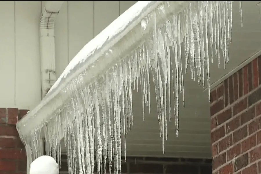 Ice collected along a residential gutter edge