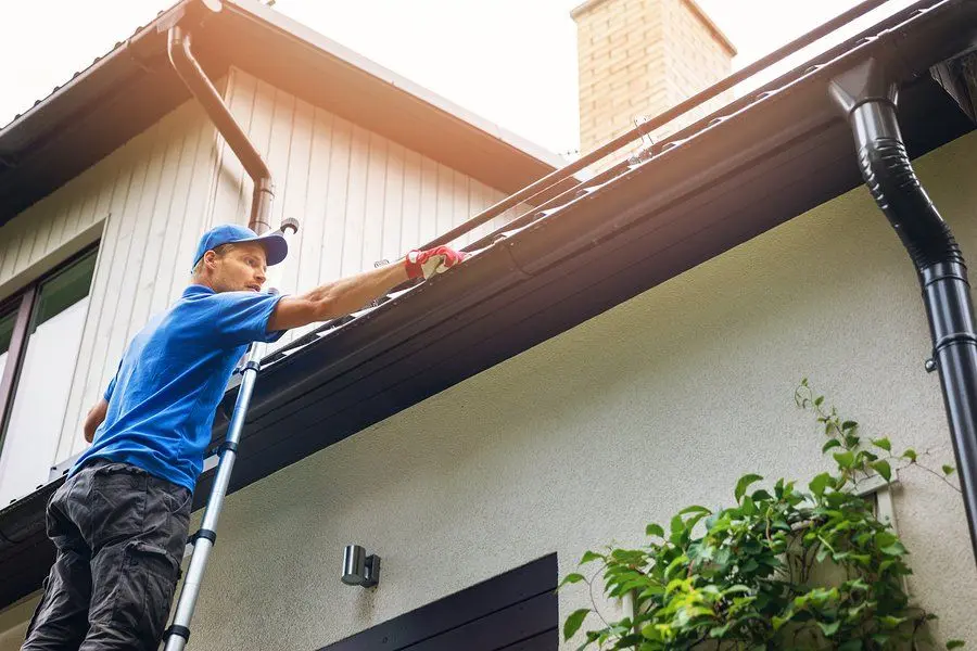 Fitting a guard over an open residential gutter